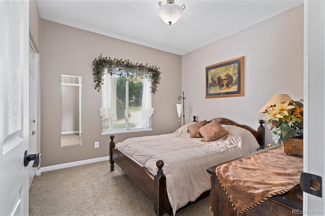 bedroom featuring baseboards and carpet flooring