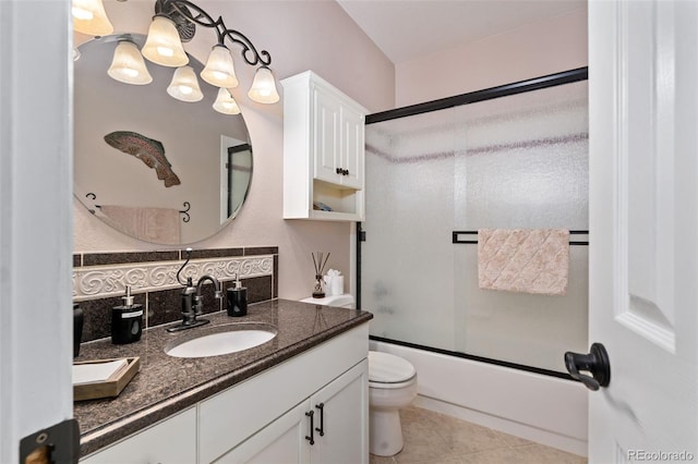 full bath featuring tile patterned flooring, enclosed tub / shower combo, vanity, and toilet