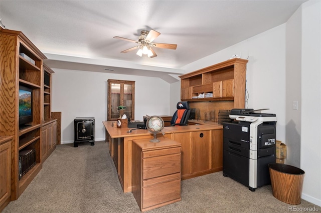 home office featuring light colored carpet, ceiling fan, and baseboards