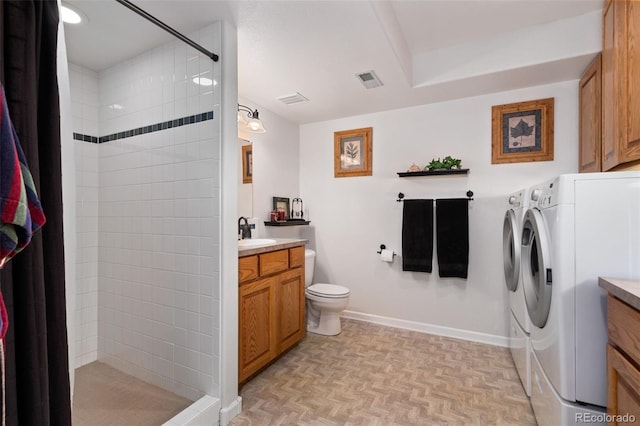 full bathroom with toilet, vanity, baseboards, independent washer and dryer, and a stall shower