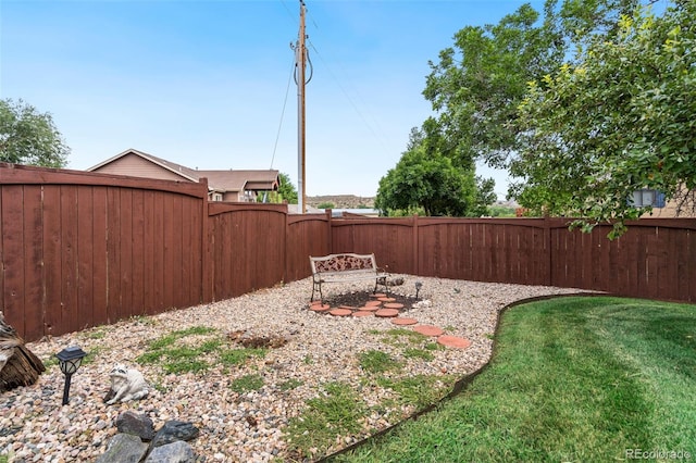 view of yard with a fenced backyard and a gate