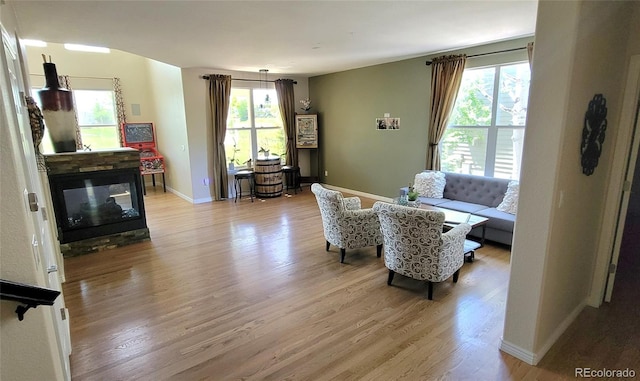 5049 Heatherglen Dr, Highlands Ranch, CO 80130 - living room featuring wood finished floors, baseboards, and a stone fireplace