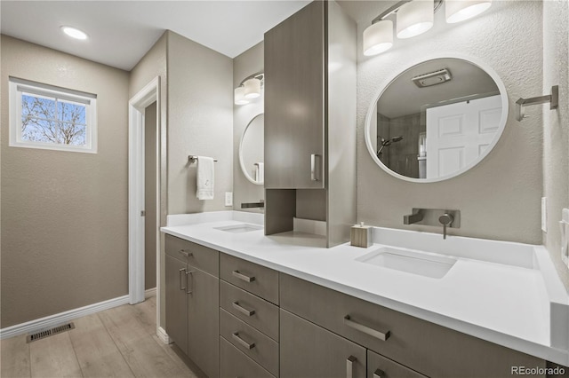 5049 Heatherglen Dr, Highlands Ranch, CO 80130 - bathroom featuring double vanity, wood finished floors, and baseboards