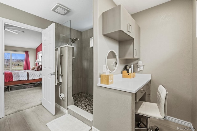 5049 Heatherglen Dr, Highlands Ranch, CO 80130 - bathroom featuring ensuite bathroom, walk in shower, wood finished floors, and a ceiling fan