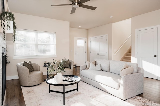 living room featuring hardwood / wood-style flooring and ceiling fan