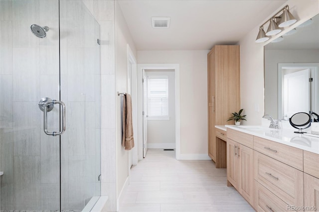 bathroom featuring vanity and a shower with shower door