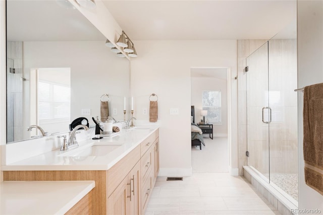 bathroom with vanity, tile patterned floors, and a shower with shower door