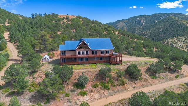 exterior space with a deck with mountain view