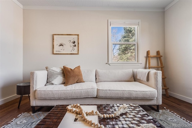 living room with baseboards, wood finished floors, and crown molding