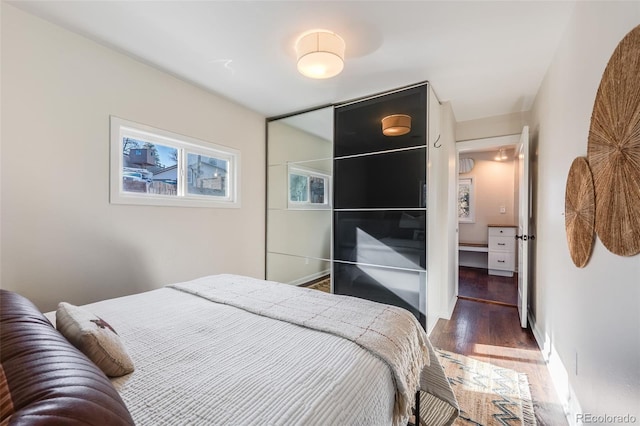 bedroom featuring baseboards and wood finished floors