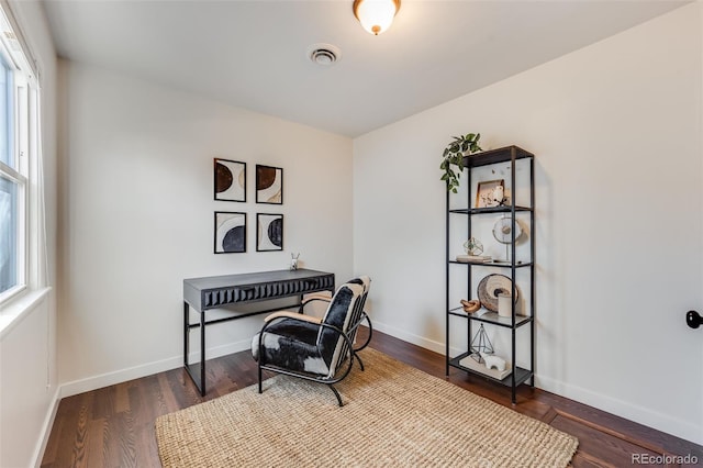 office with visible vents, baseboards, and wood finished floors