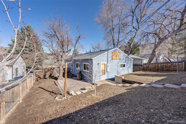 view of side of home with a patio area and a fenced backyard