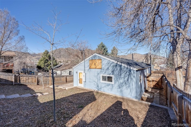 back of house with a fenced backyard