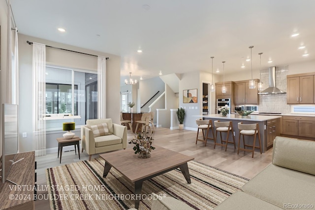 living room featuring light hardwood / wood-style floors and a notable chandelier