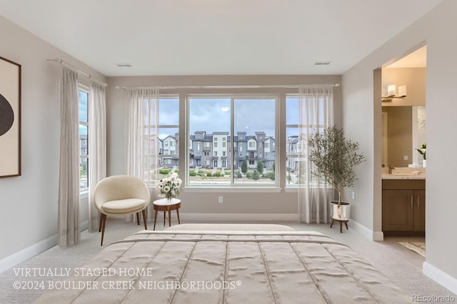 living area featuring sink, a healthy amount of sunlight, and carpet flooring