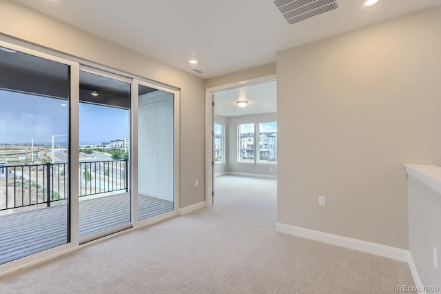 unfurnished room with light colored carpet