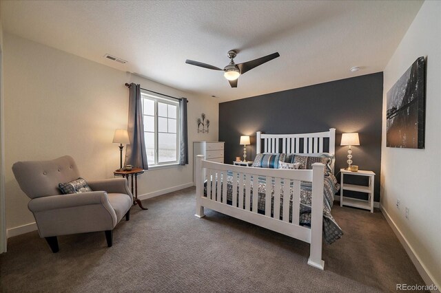 bedroom with visible vents, dark carpet, ceiling fan, a textured ceiling, and baseboards