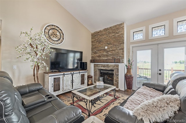 42313 Vista Rdg, Parker, CO 80138 - living area featuring high vaulted ceiling, dark wood finished floors, french doors, and a stone fireplace