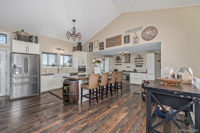 42313 Vista Rdg, Parker, CO 80138 - kitchen with stainless steel appliances, dark wood finished floors, a kitchen bar, white cabinetry, and a kitchen island