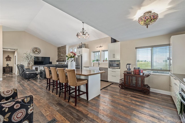 42313 Vista Rdg, Parker, CO 80138 - kitchen featuring stainless steel appliances, dark wood finished floors, white cabinetry, a kitchen breakfast bar, and a chandelier
