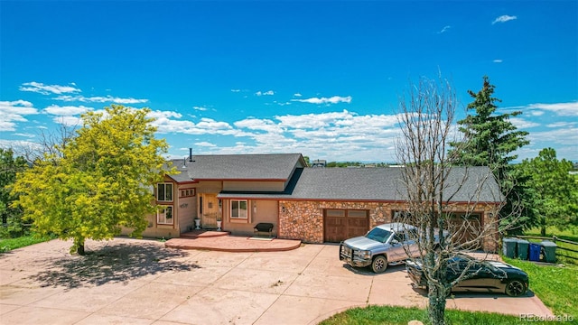 42313 Vista Rdg, Parker, CO 80138 - view of front facade with an attached garage, concrete driveway, stone siding, and a shingled roof