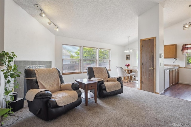 11337 E 1st Ave, Aurora, CO 80010 - living area with a chandelier, a textured ceiling, vaulted ceiling, wood finished floors, and carpet floors