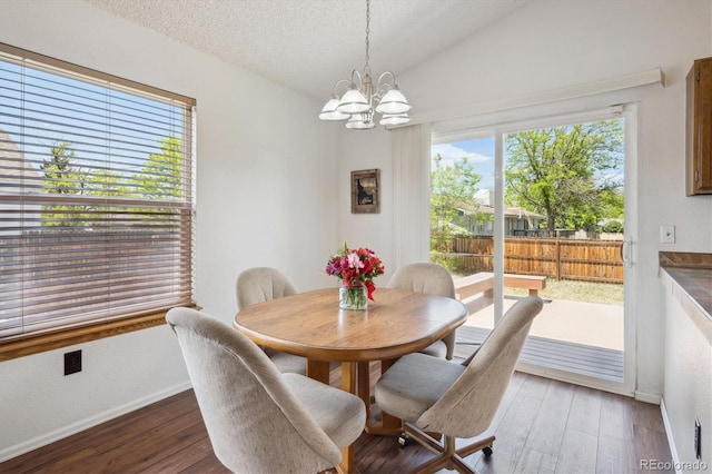 11337 E 1st Ave, Aurora, CO 80010 - dining space with a chandelier, wood finished floors, baseboards, a textured ceiling, and vaulted ceiling