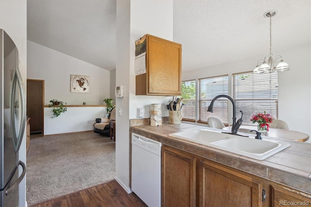 11337 E 1st Ave, Aurora, CO 80010 - kitchen with dishwasher, freestanding refrigerator, a sink, a textured ceiling, and vaulted ceiling
