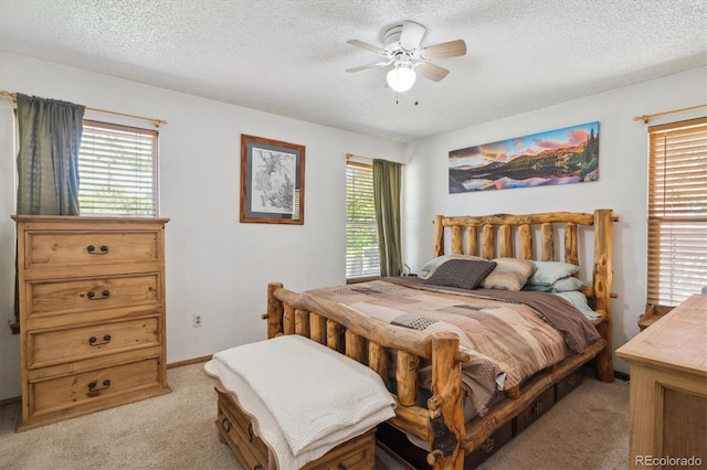 11337 E 1st Ave, Aurora, CO 80010 - bedroom featuring light carpet, multiple windows, a textured ceiling, and ceiling fan