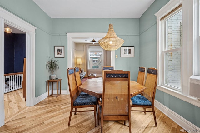 dining area with light wood-style floors and baseboards