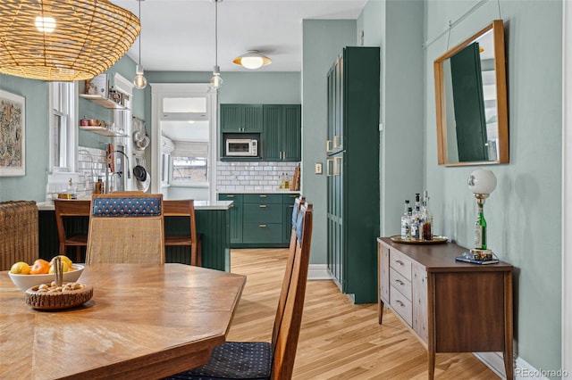 dining area featuring light wood finished floors