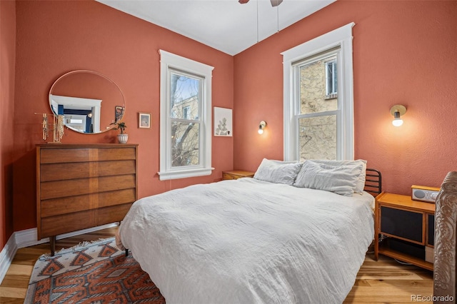 bedroom featuring a ceiling fan and wood finished floors