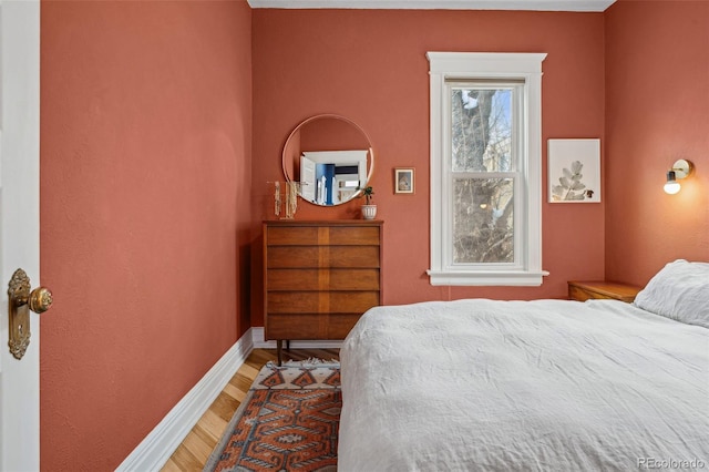 bedroom featuring light wood-style flooring and baseboards