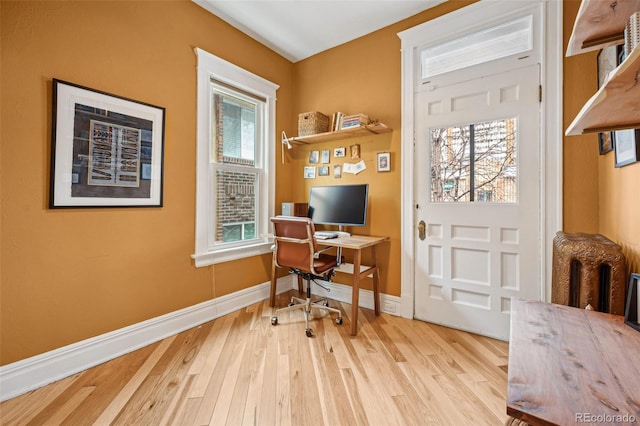 office with a wealth of natural light, baseboards, and wood finished floors