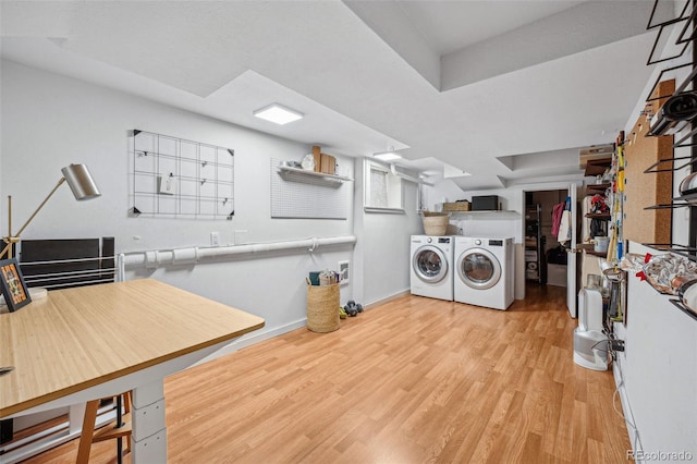 laundry area featuring laundry area, independent washer and dryer, wood finished floors, and baseboards