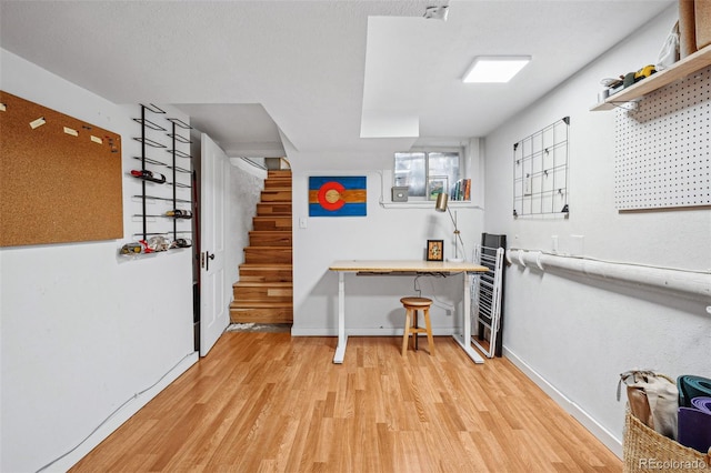 office area with baseboards and light wood-style floors