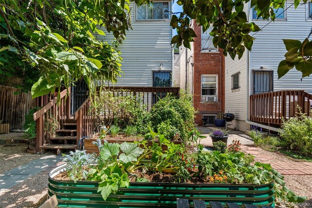 exterior space featuring a garden and fence