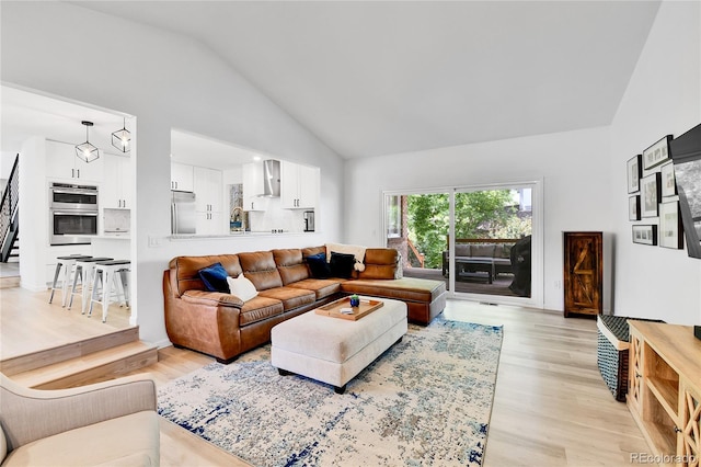 11209 Quivas Loop, Westminster, CO 80234 - living room featuring light wood finished floors and high vaulted ceiling