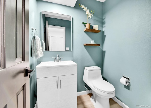 11209 Quivas Loop, Westminster, CO 80234 - bathroom featuring toilet, vanity, wood finished floors, and baseboards