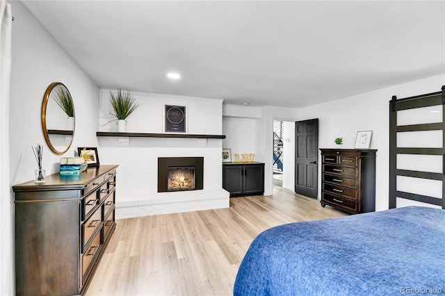 11209 Quivas Loop, Westminster, CO 80234 - bedroom with light wood finished floors, a fireplace, and recessed lighting