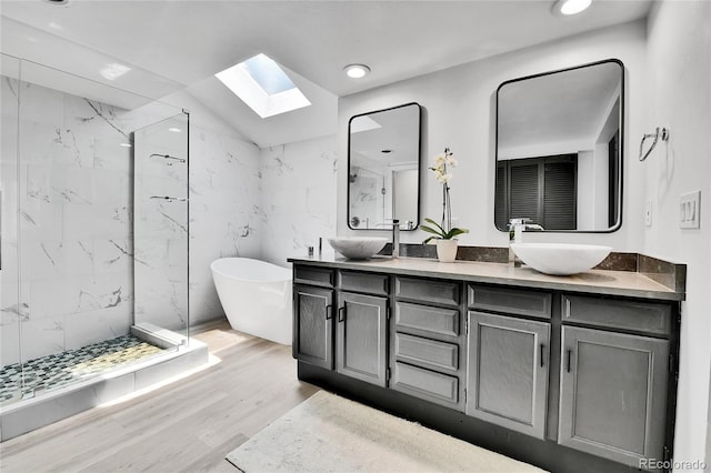 11209 Quivas Loop, Westminster, CO 80234 - full bath featuring a skylight, a marble finish shower, double vanity, a freestanding bath, and recessed lighting