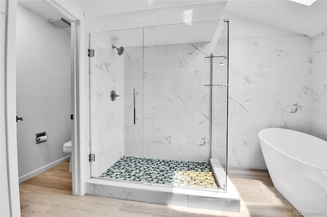 11209 Quivas Loop, Westminster, CO 80234 - full bath with a marble finish shower, a freestanding bath, wood finished floors, and toilet