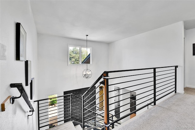 11209 Quivas Loop, Westminster, CO 80234 - stairway featuring a chandelier, carpet floors, and baseboards