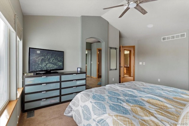 bedroom with ceiling fan, light colored carpet, multiple windows, and lofted ceiling