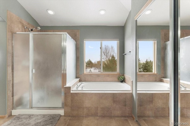 bathroom with tile patterned flooring, independent shower and bath, and a healthy amount of sunlight