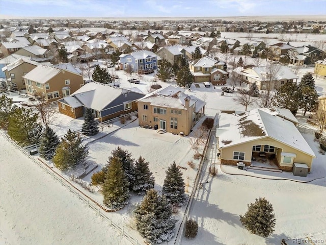 snowy aerial view with a residential view