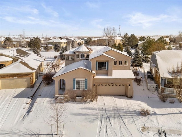 view of front of property featuring a residential view, stucco siding, driveway, and a garage