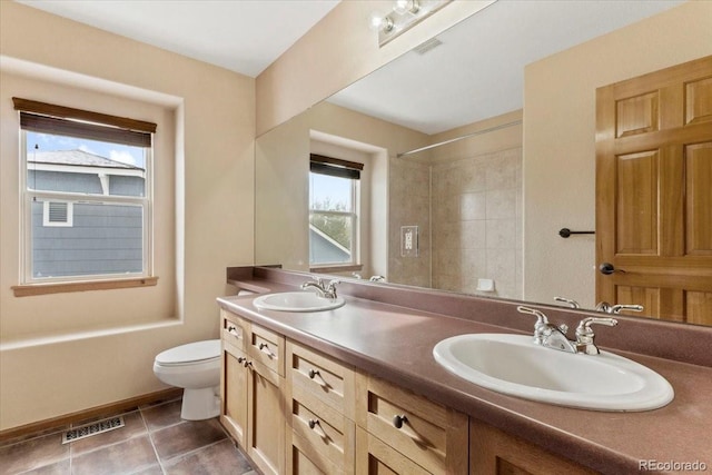 bathroom with tile patterned floors, visible vents, toilet, and a sink