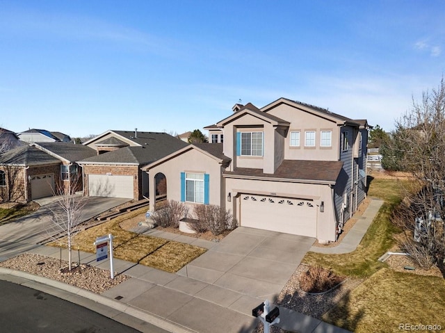 traditional-style home featuring stucco siding, a garage, and concrete driveway