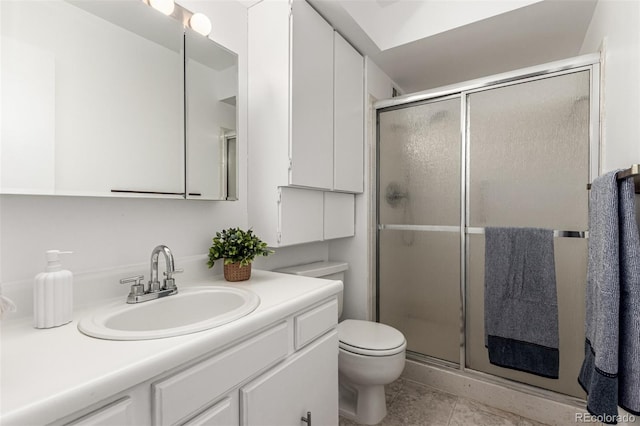 bathroom featuring vanity, toilet, tile patterned floors, and walk in shower